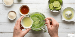 Next, pour the blended cucumber mixture into a large pitcher. Then, add the freshly squeezed lime juice and your preferred sweetener.