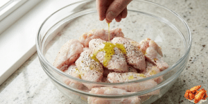 Place the wings in a large bowl. Add avocado oil, salt, and black pepper. Toss until evenly coated.